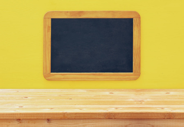 Empty vintage blackboard on wooden background - Photo, Image
