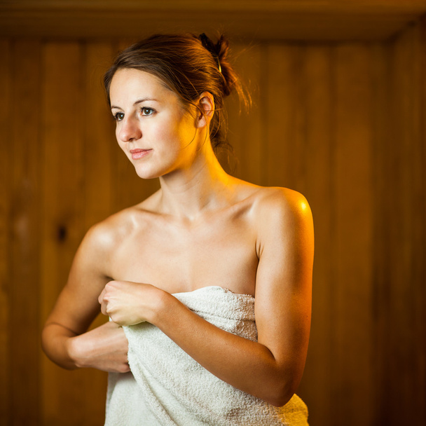 Young woman relaxing in a sauna - Zdjęcie, obraz