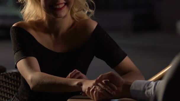 Coppia seduta a tavola in terrazza, femmina che dà la mano al maschio, flirtando
 - Filmati, video