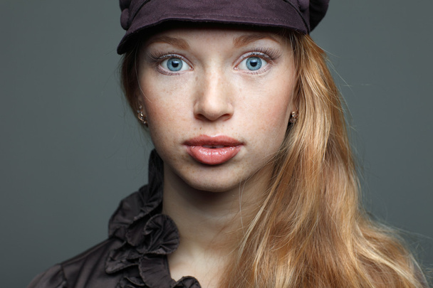 Closeup portrait of sexy redheaded young woman with beautiful blue eyes on white background - Valokuva, kuva