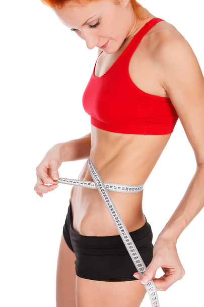 Mujer midiendo cintura con cinta métrica
 - Foto, Imagen