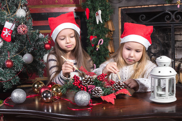beautiful girls decorating christmas toys - Fotografie, Obrázek