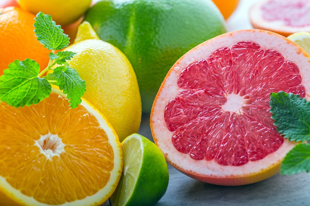 Citrus fresh fruit. Orange grapefruit lemon lime with mint leaves - Фото, изображение