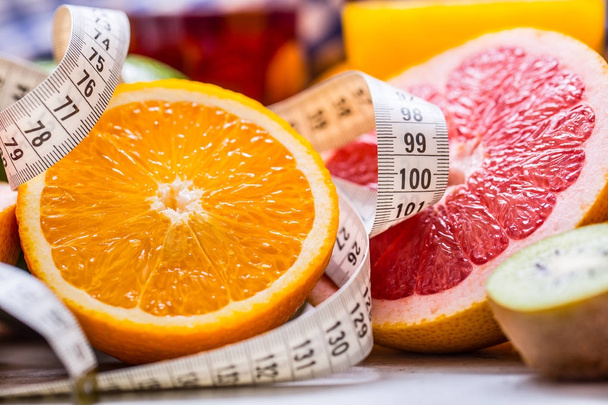Measure tape and fresh citrus fruit orange lemon tangerine lime lemon and grapefruit - Zdjęcie, obraz