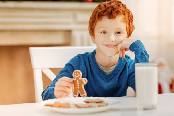 Relaxed curly haired child enjoying christmas breakfast - Foto, Bild