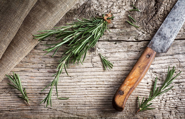 Branches of fresh rosemary, vintage wooden background - Fotó, kép