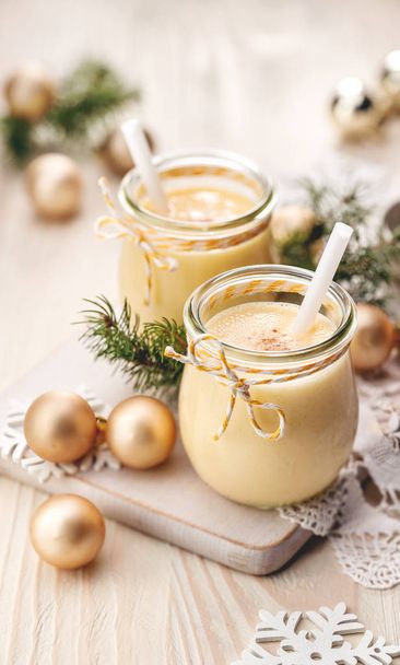 Eggnog alcoholic beverage served with cinnamon or nutmeg.  Traditional drink often served during Christmas - Photo, Image