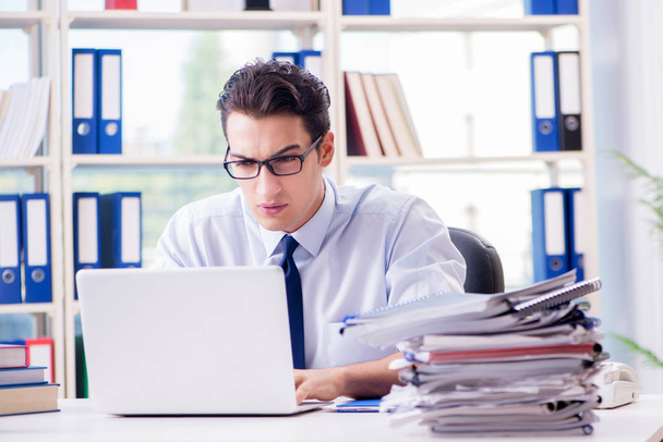 Businessman with excessive work paperwork working in office - Photo, image