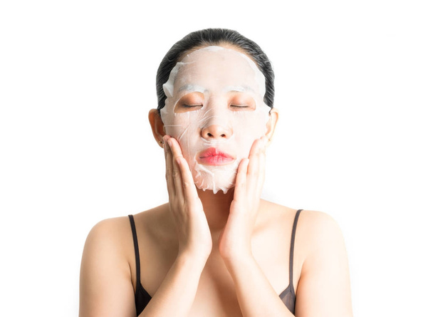 Młoda kobieta robi twarzy maski arkusza z oczyszczania maski na jej f - Zdjęcie, obraz