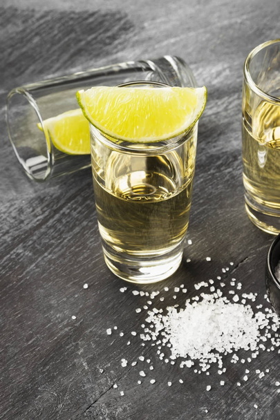 Tequila with lime and salt on a dark background - Φωτογραφία, εικόνα