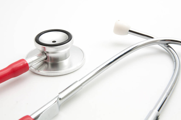 Close -up red stethoscope on white background - Foto, imagen