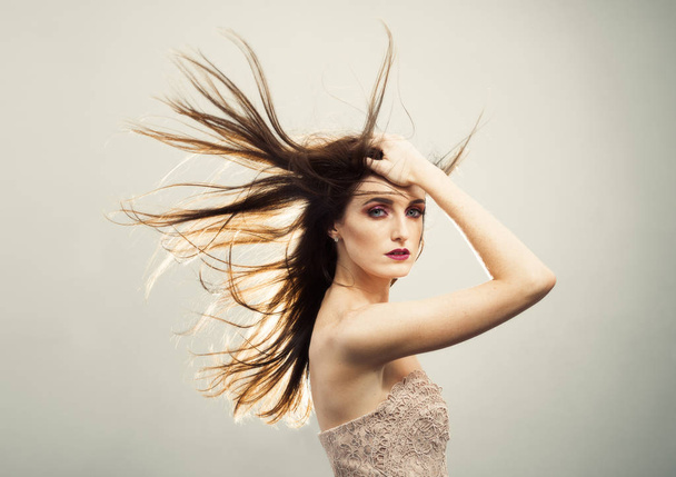 Beautiful Young Woman With Windswept Hair - Φωτογραφία, εικόνα