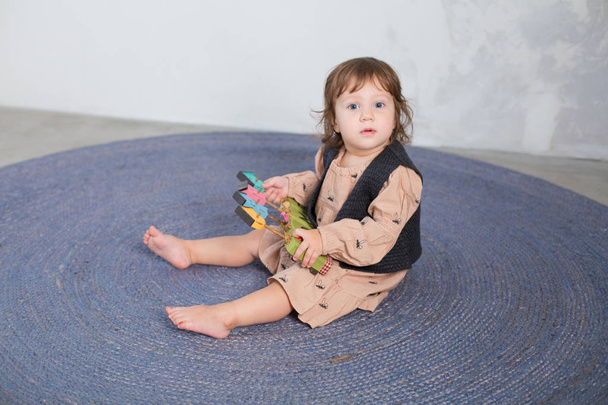 Little happy girl playing with toy on floor. - Valokuva, kuva