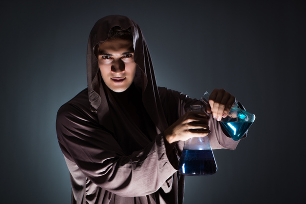Alchemist doing experiments in alchemy concept - Photo, Image
