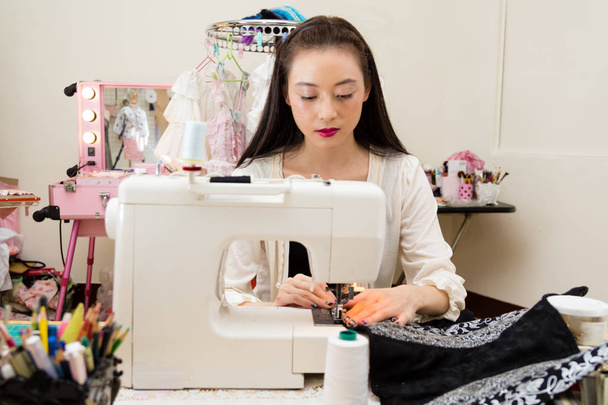 Fashion designer at sewing machine - 写真・画像