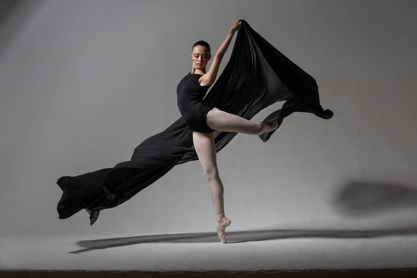 Graceful ballerina posing with black cloth - Fotoğraf, Görsel