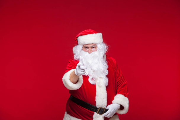 Santa Claus is dancing Isolated on red background. - Photo, Image