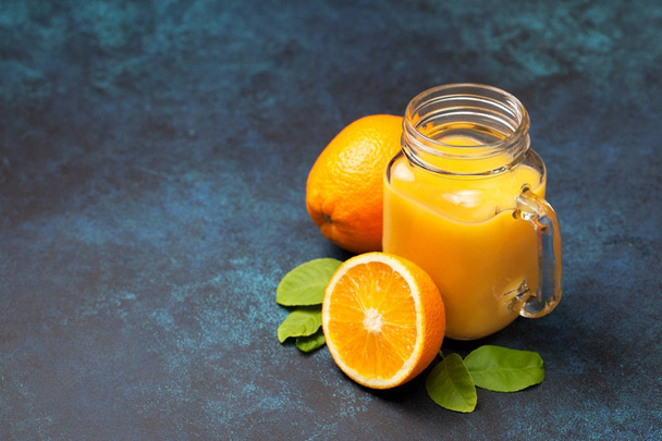 orange juice in a mason jar - Фото, изображение