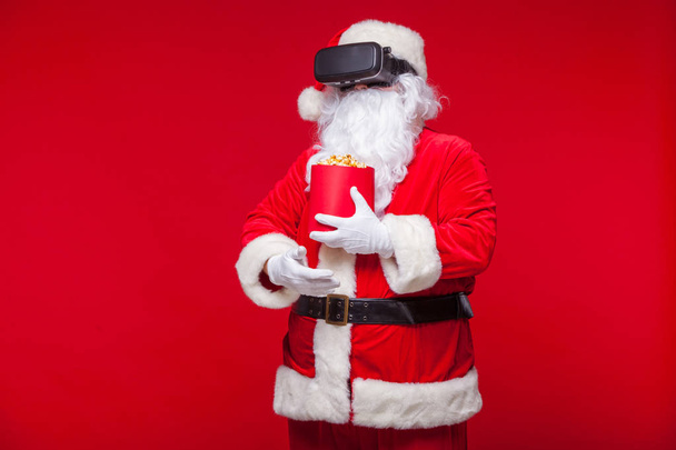 Santa Claus wearing virtual reality goggles and a red bucket wit - Photo, image