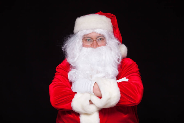 Christmas. Santa Claus portrait smiling against black background. - Photo, Image