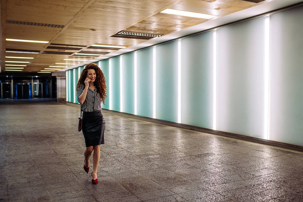 Young redhead business woman walking to work - Photo, Image