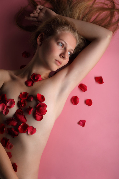 Beauty woman in rose petal - Fotó, kép