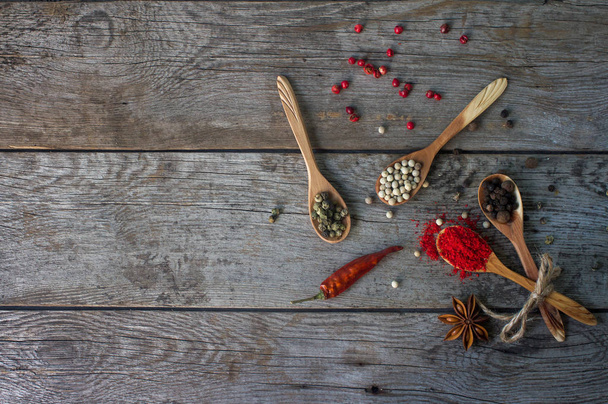 pepper mix in wooden spoons on rustic table, colorful indian spices - Fotografie, Obrázek
