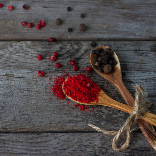 pepper mix in wooden spoons on rustic table, colorful indian spices - Fotografie, Obrázek