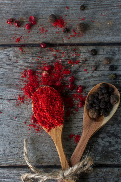 pepper mix in wooden spoons on rustic table, colorful indian spices - 写真・画像