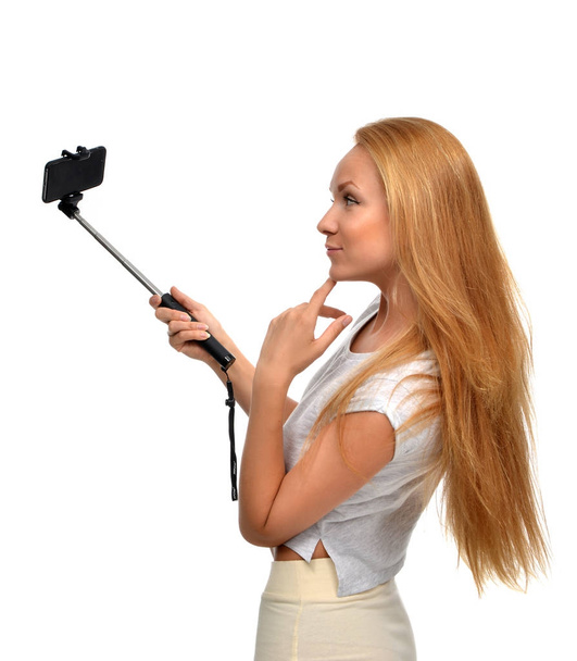 Portrait of beautiful red hair woman making selfie with stick  - Foto, immagini