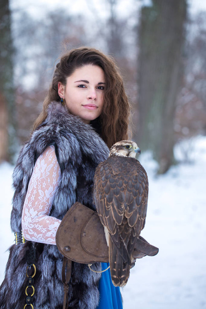 woman and falcon in winter - Photo, Image