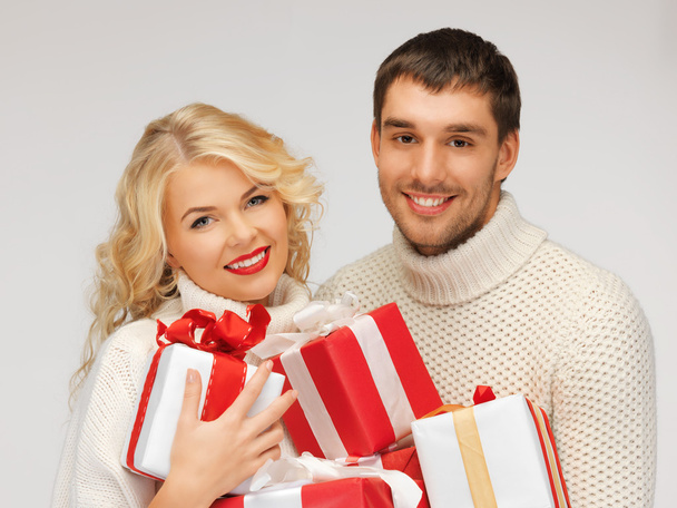 family couple in a sweaters with gift boxes - Φωτογραφία, εικόνα