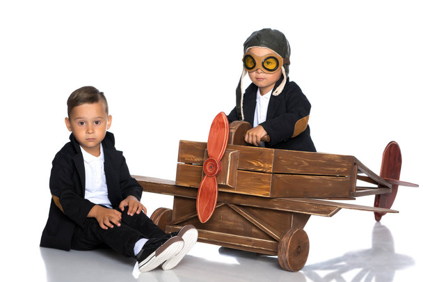 Два маленьких хлопчика грають з іграшковим літаком
. - Фото, зображення
