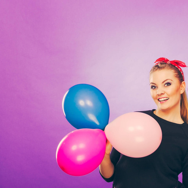 Lovely smiling girl holds colorful balloons. - Foto, immagini