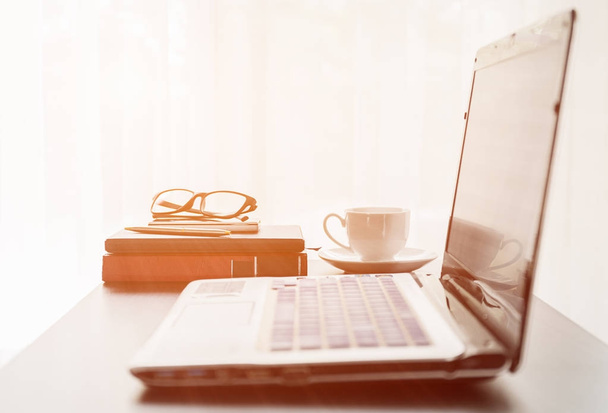 Laptop placed on desktop with coffee cup - 写真・画像