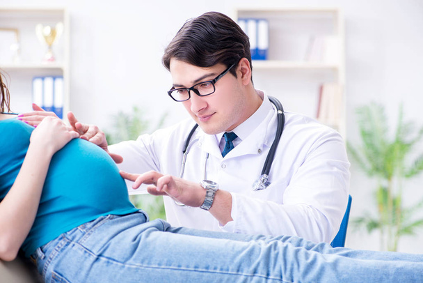 Pregnant woman visiting doctor in medical concept - Photo, Image