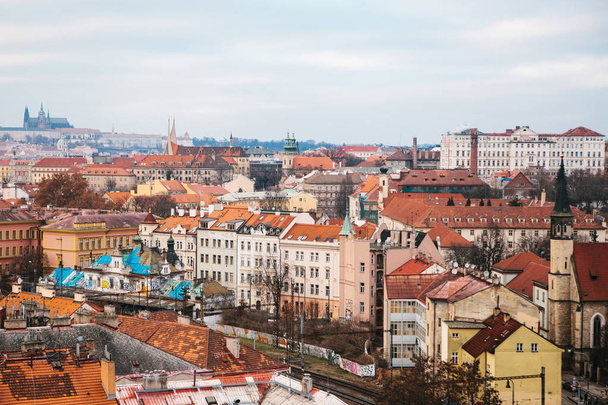 View from a high point. A beautiful view from above on the streets, roads and roofs of houses in Prague. Traditional ancient urban architecture. - Foto, Imagen