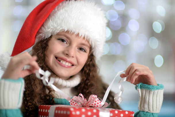  little girl with Christmas present - Фото, изображение