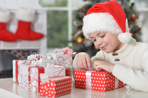 boy  in Santa hat with gifts - Fotó, kép