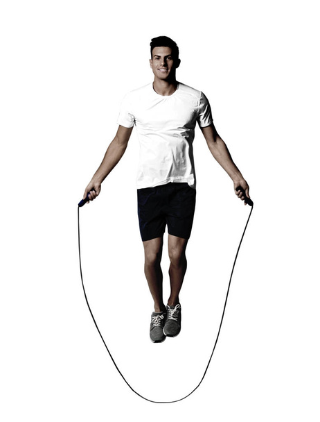 Young man with jumping rope on white background - Photo, image