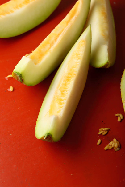 Sweet organic melon on red - Foto, imagen