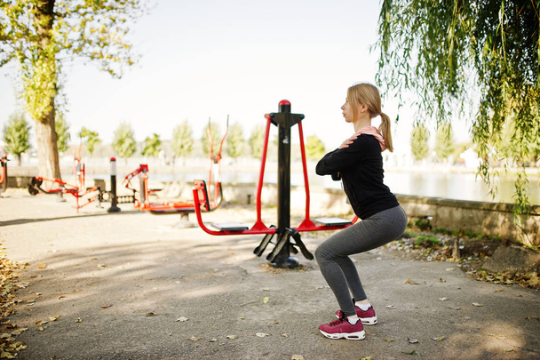 Young girl has the training and doing exercise outdoors on stree - 写真・画像