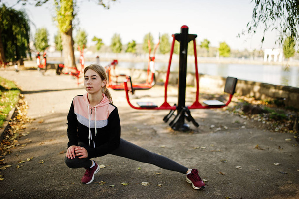 Young girl has the training and doing exercise outdoors on stree - Фото, зображення