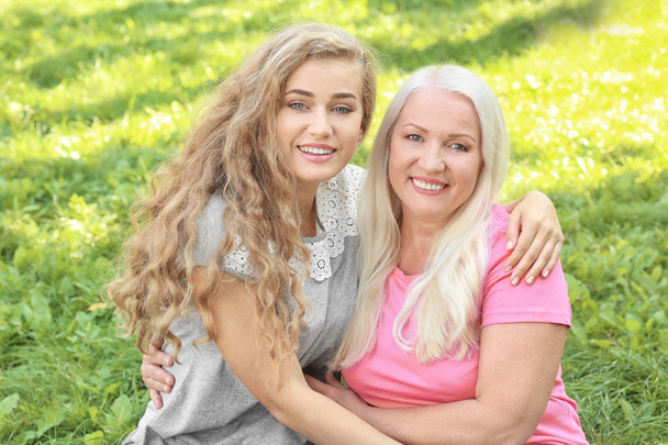 Young woman and her mother together in park - Photo, Image