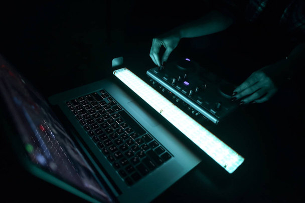 DJ mixer disco illuminated by searchlights - Foto, imagen