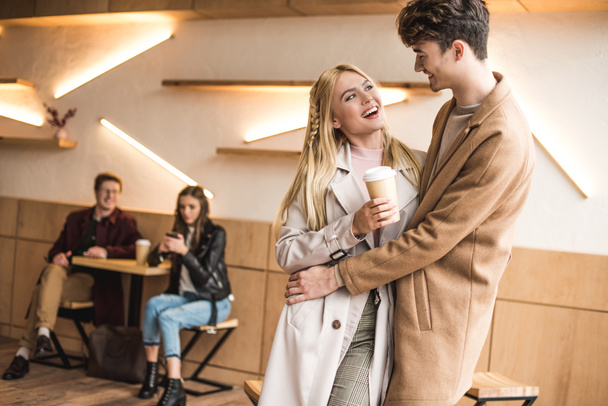 Boyfriend hugging girlfriend in cafe - Foto, Imagen