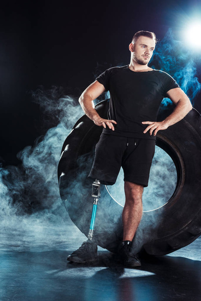 paralympic sportsman leaning on tire - 写真・画像