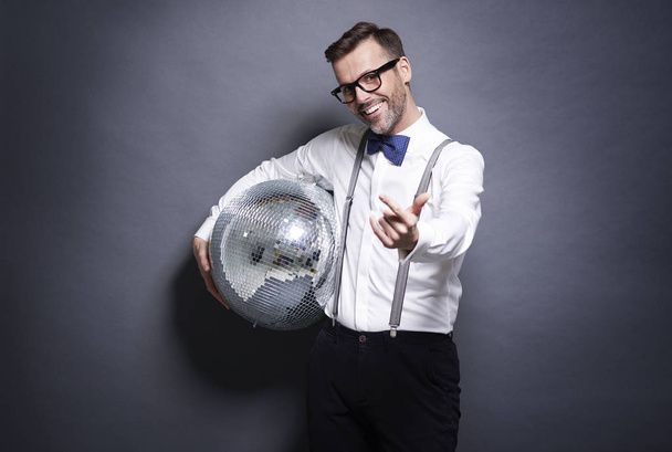 Man holding a disco bal - Foto, afbeelding