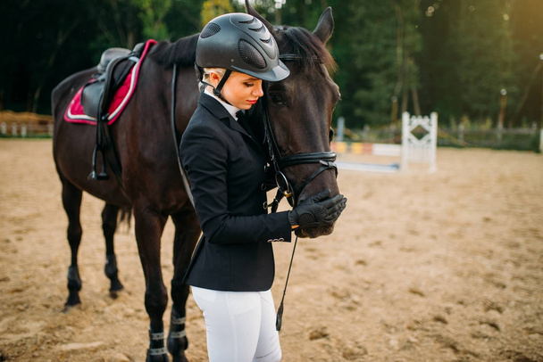 female jockey posing with horse - Fotografie, Obrázek