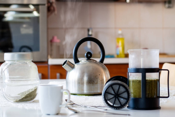 Morning yerba tea. Tasty tea brewed in cafetiere on the kitchen  - Fotoğraf, Görsel